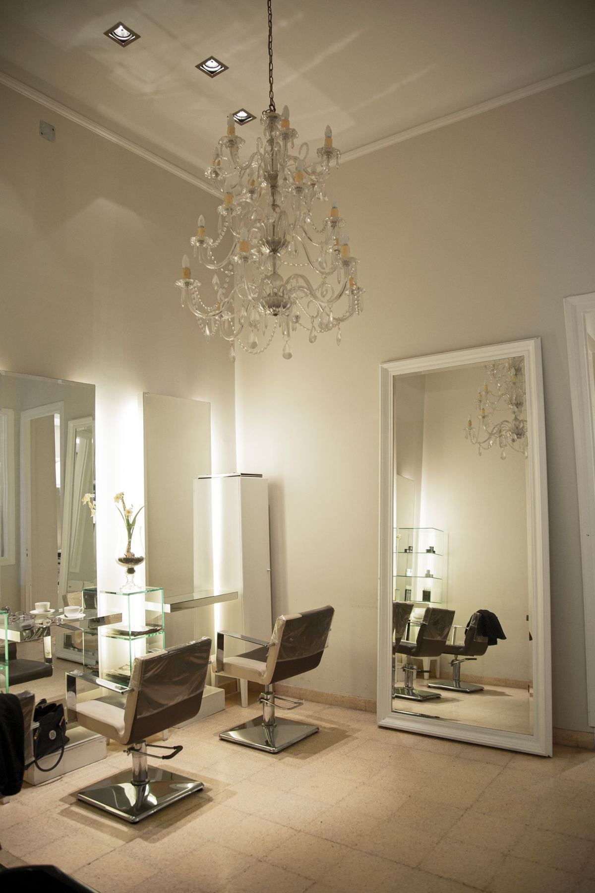 A salon interior with large mirrors and styling chairs