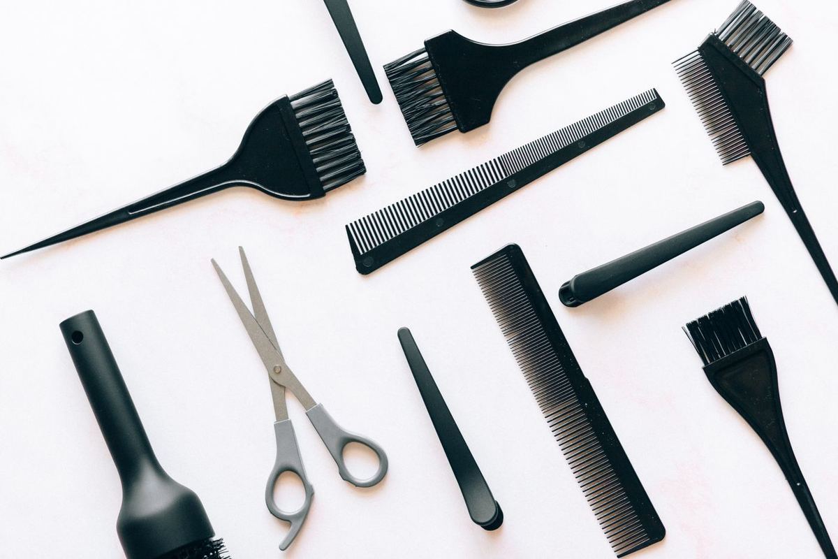 Hairdressing scissors, combs and brushes laid out