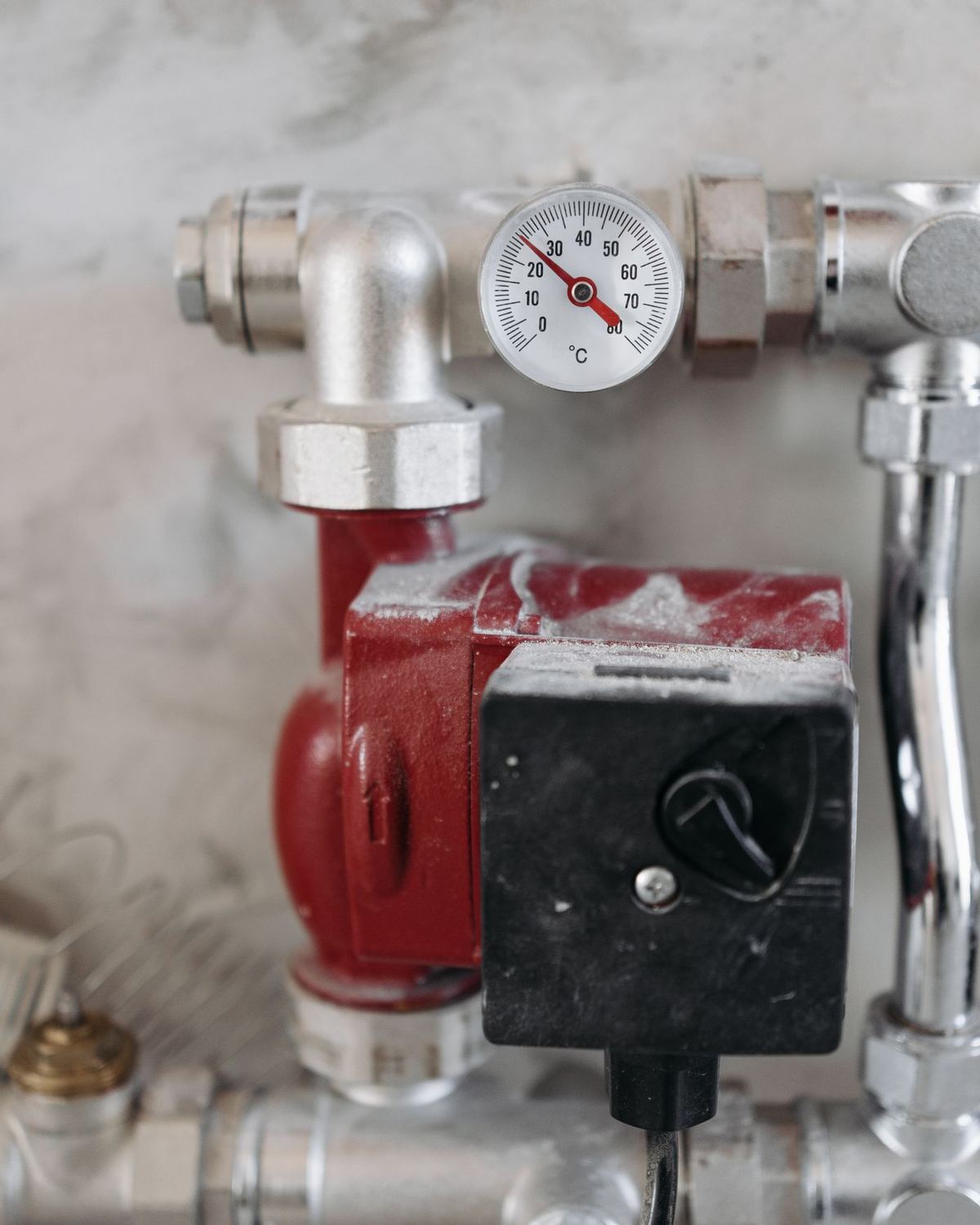 A heating pump and pressure gauge on copper pipework