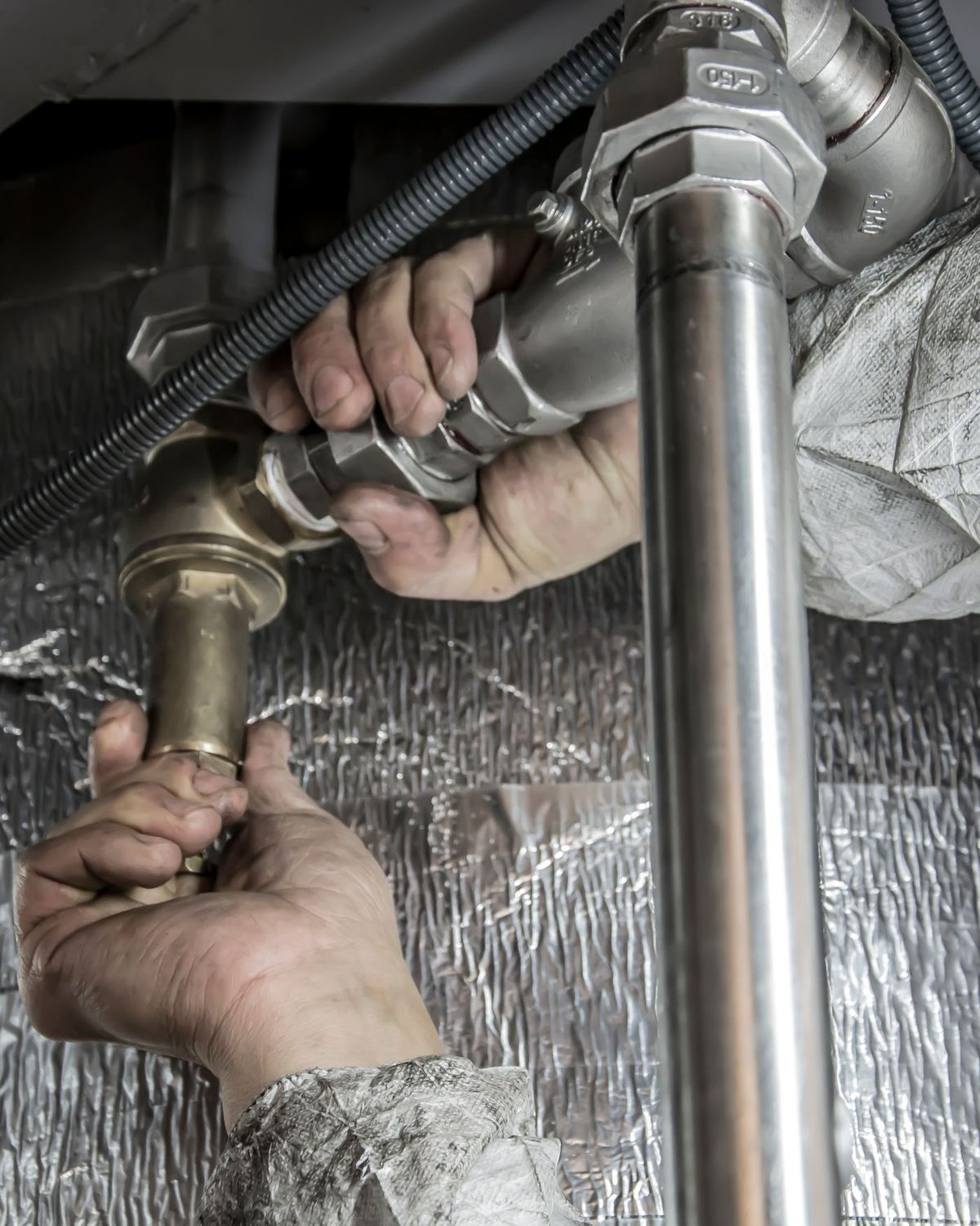 Hands fitting a pipe
