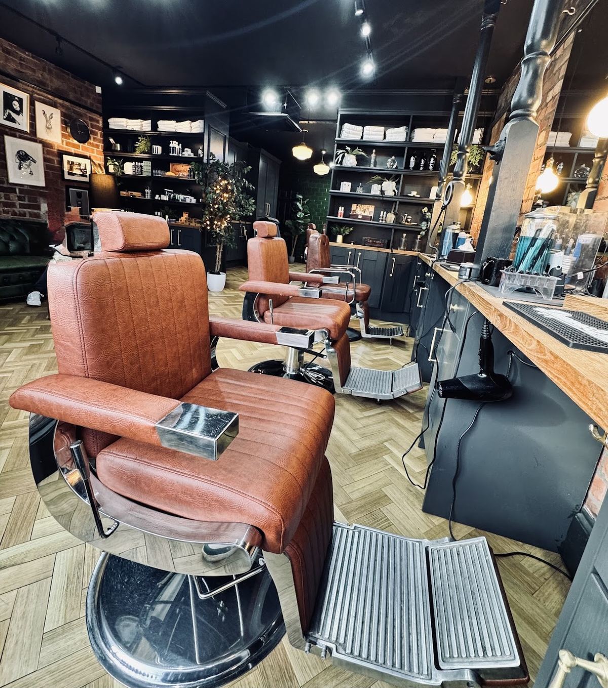 A tan leather barber chair at its station inside Bear and Hare Barbers