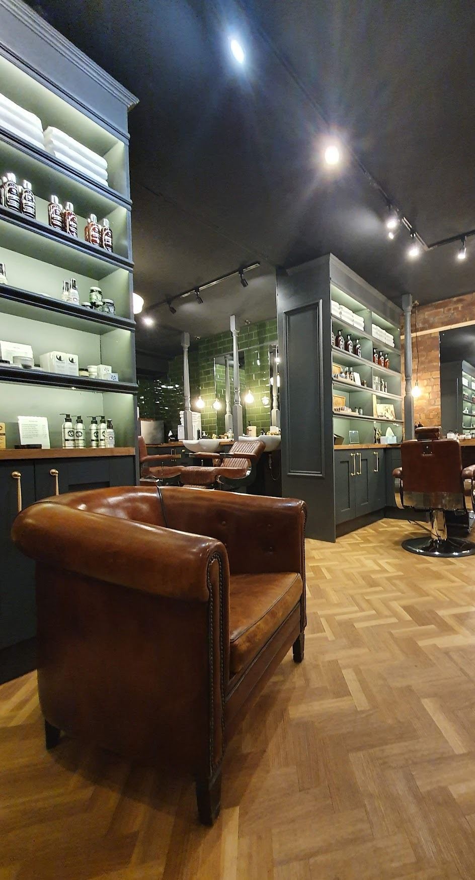 The leather armchair and product shelving inside Bear and Hare Barbers