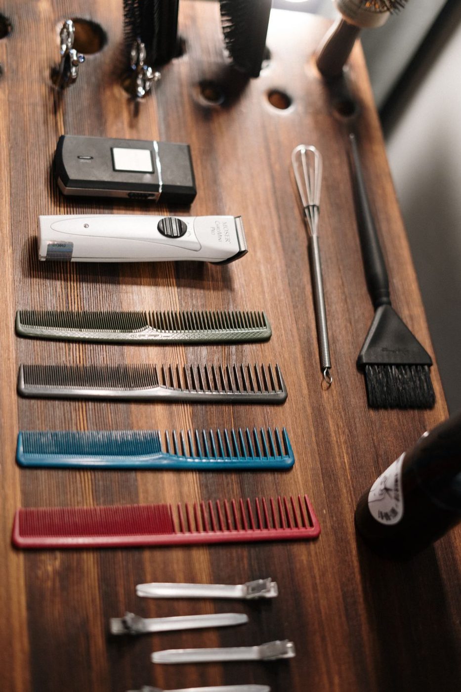 A stylist's tools set out on a wooden bench