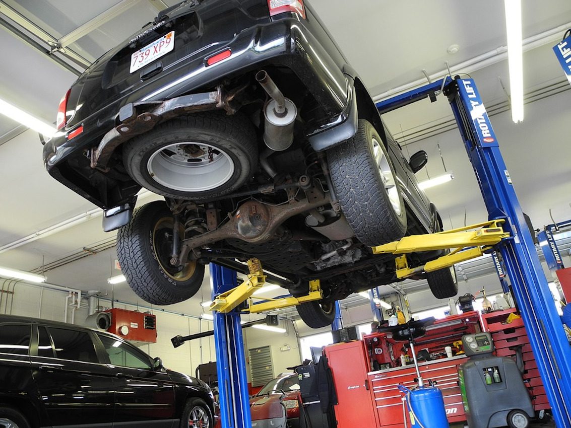 A car up on the two-post lift inside the D S P Autos workshop