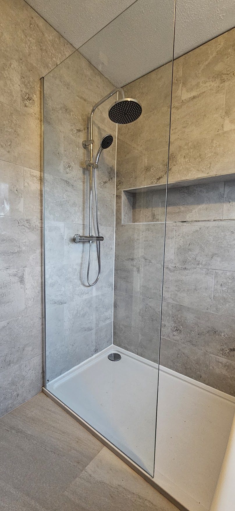 Walk-in shower with marble tiling