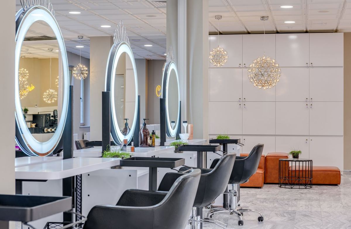 A bright hair salon with mirrored styling stations