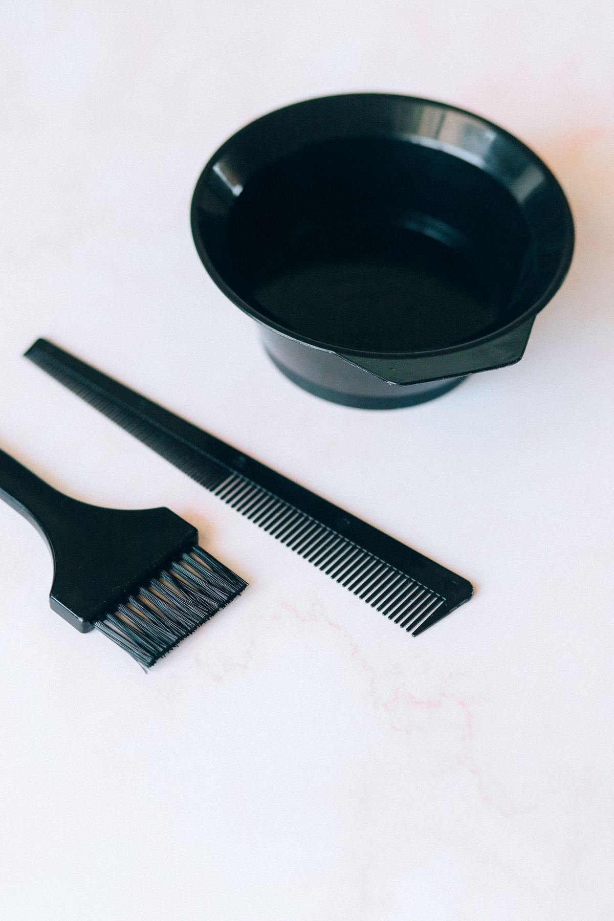 A tint bowl, tint brush and comb laid out ready for a colour