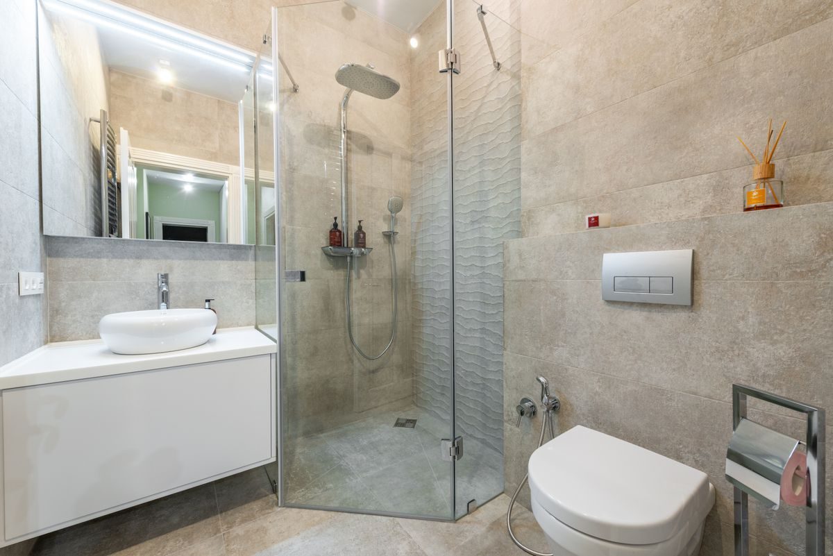 A walk-in shower and wall-hung basin
