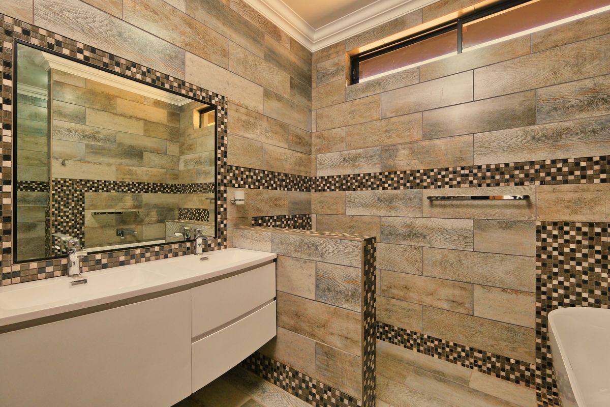 A tiled bathroom with a wall-hung vanity unit