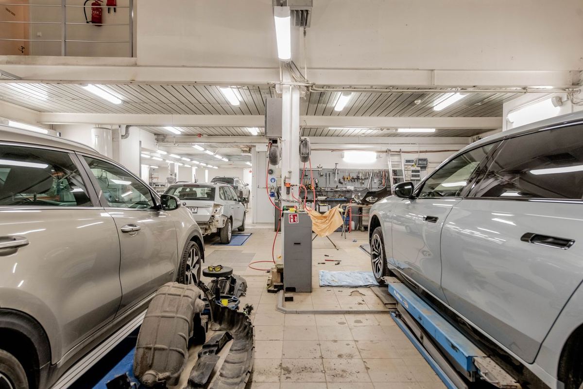 A working garage workshop with cars on ramps