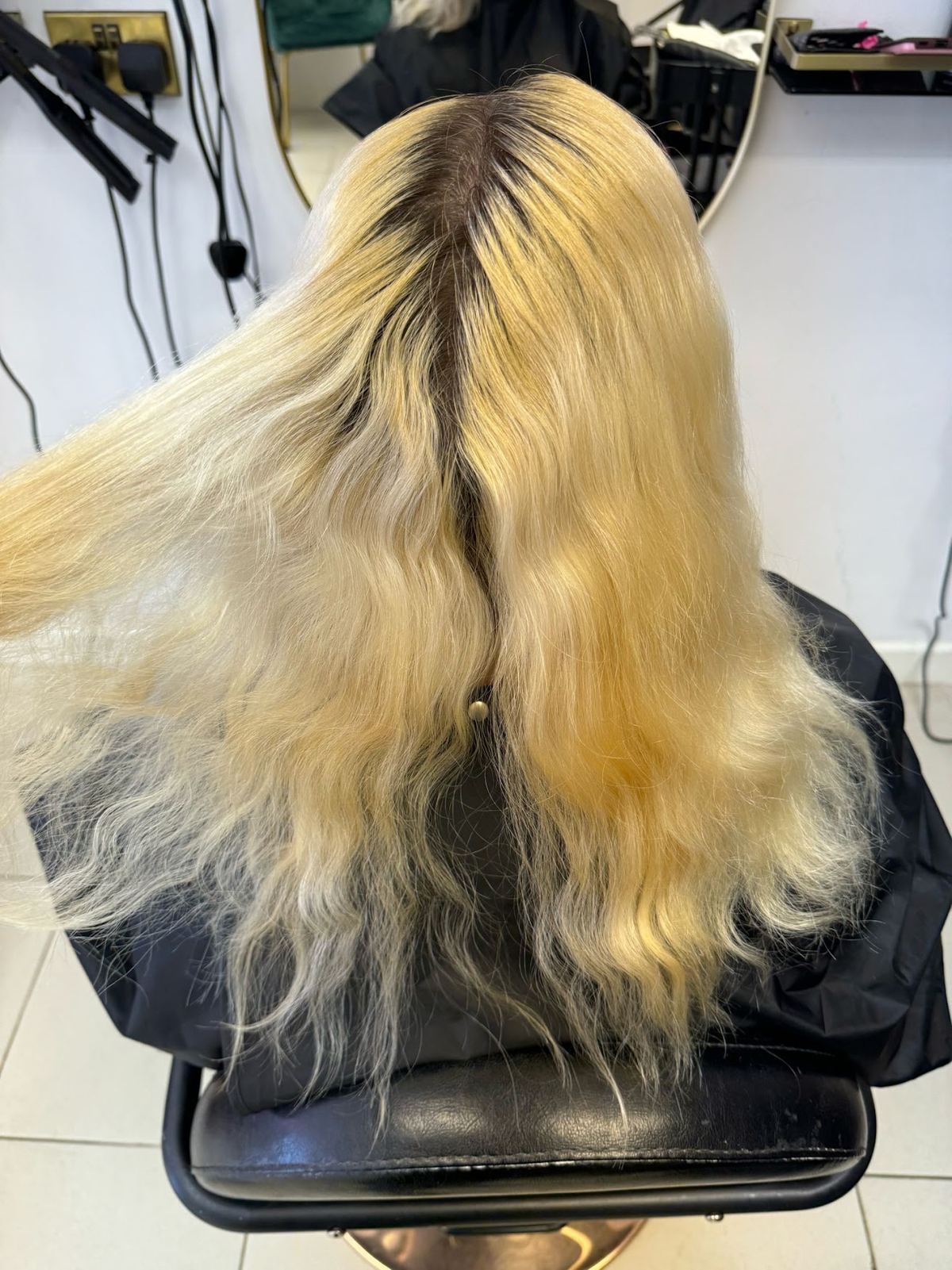 Long blonde hair being worked on in the chair at Nicci Jane Hair