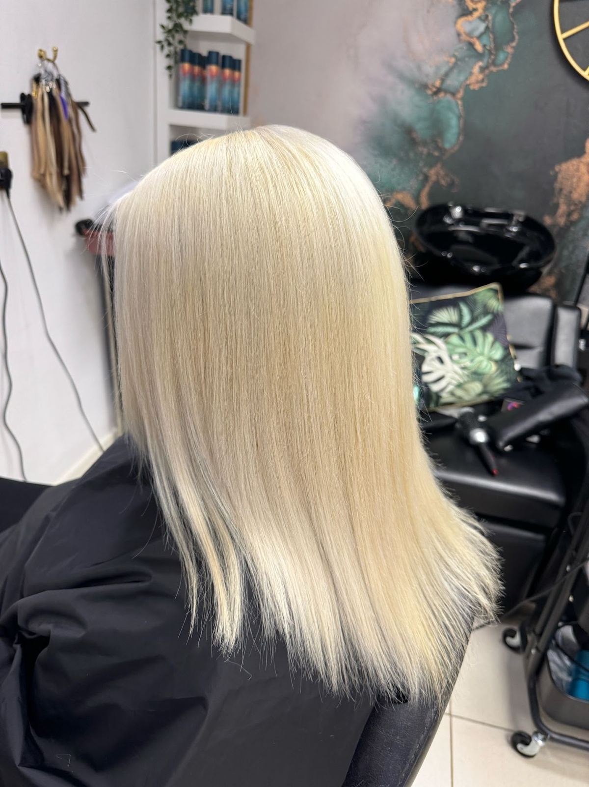 A finished blonde cut photographed from behind at Nicci Jane Hair