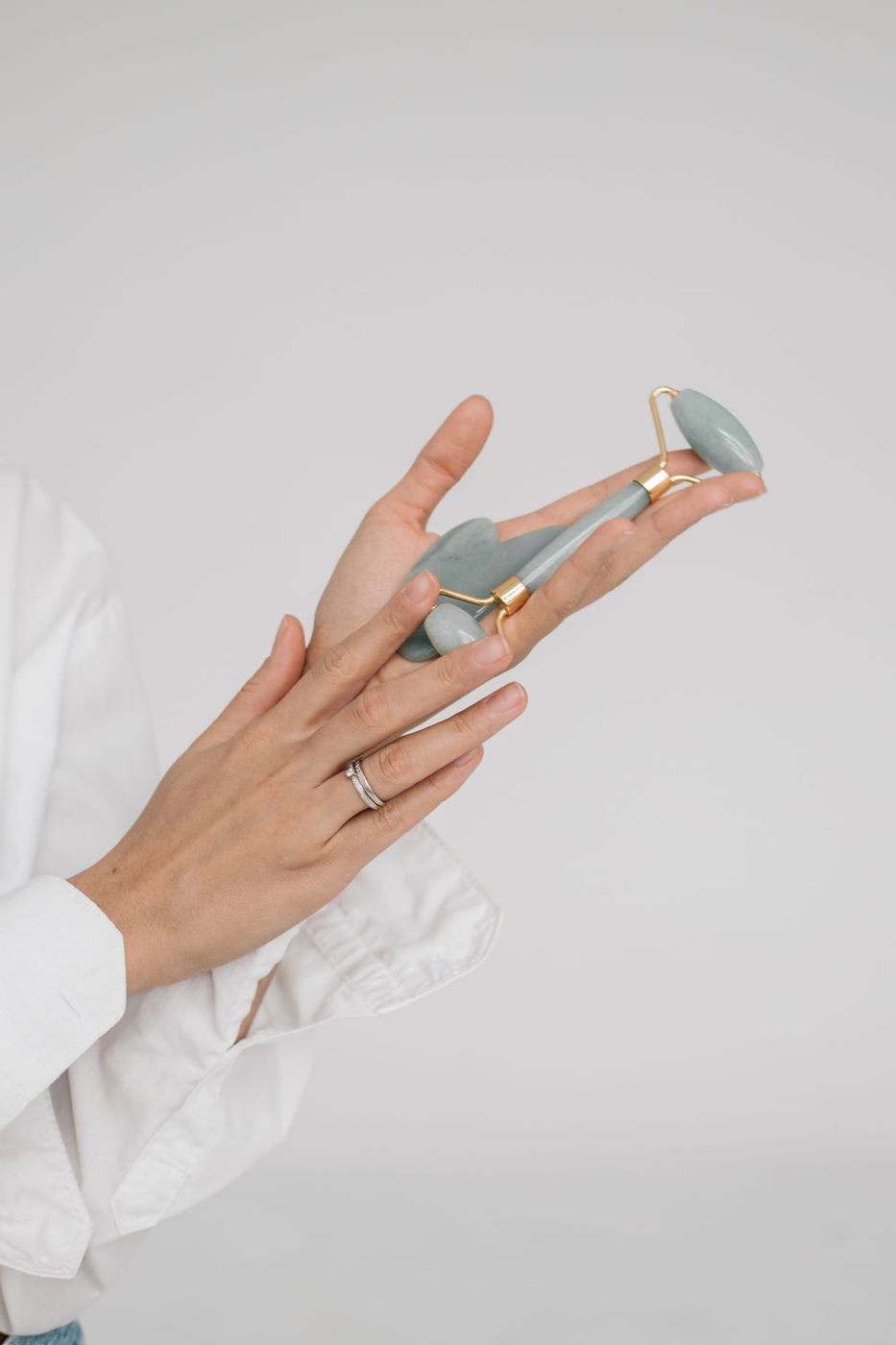 Hands holding a gua sha stone