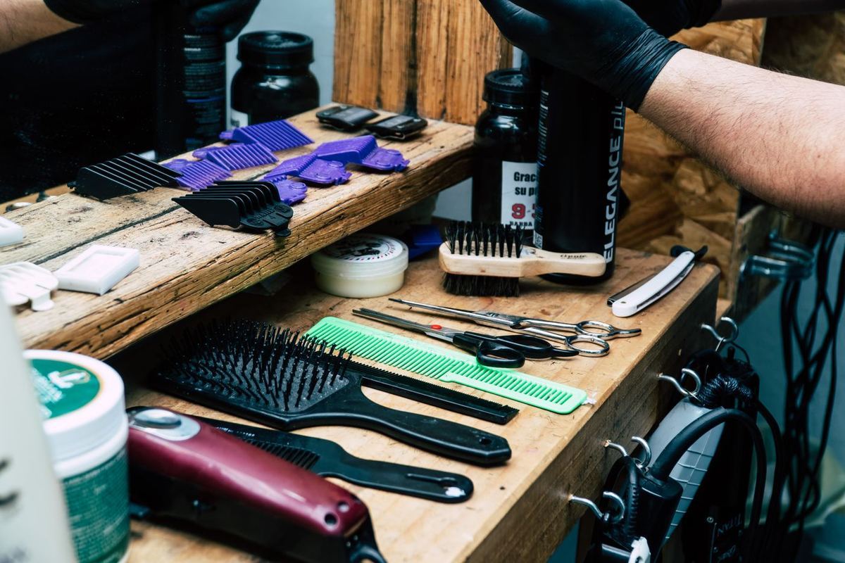 Barber tools laid out on a wooden counter