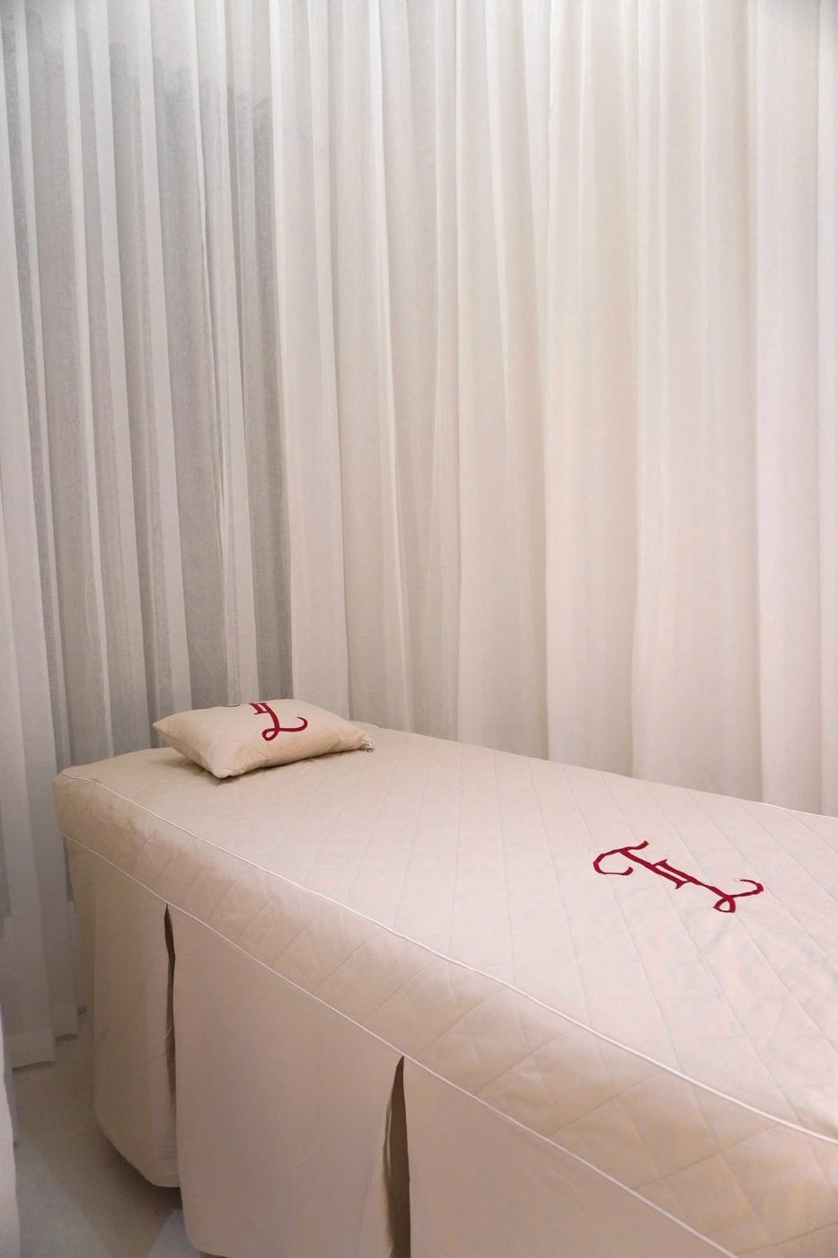 A treatment bed made up with fresh white covers