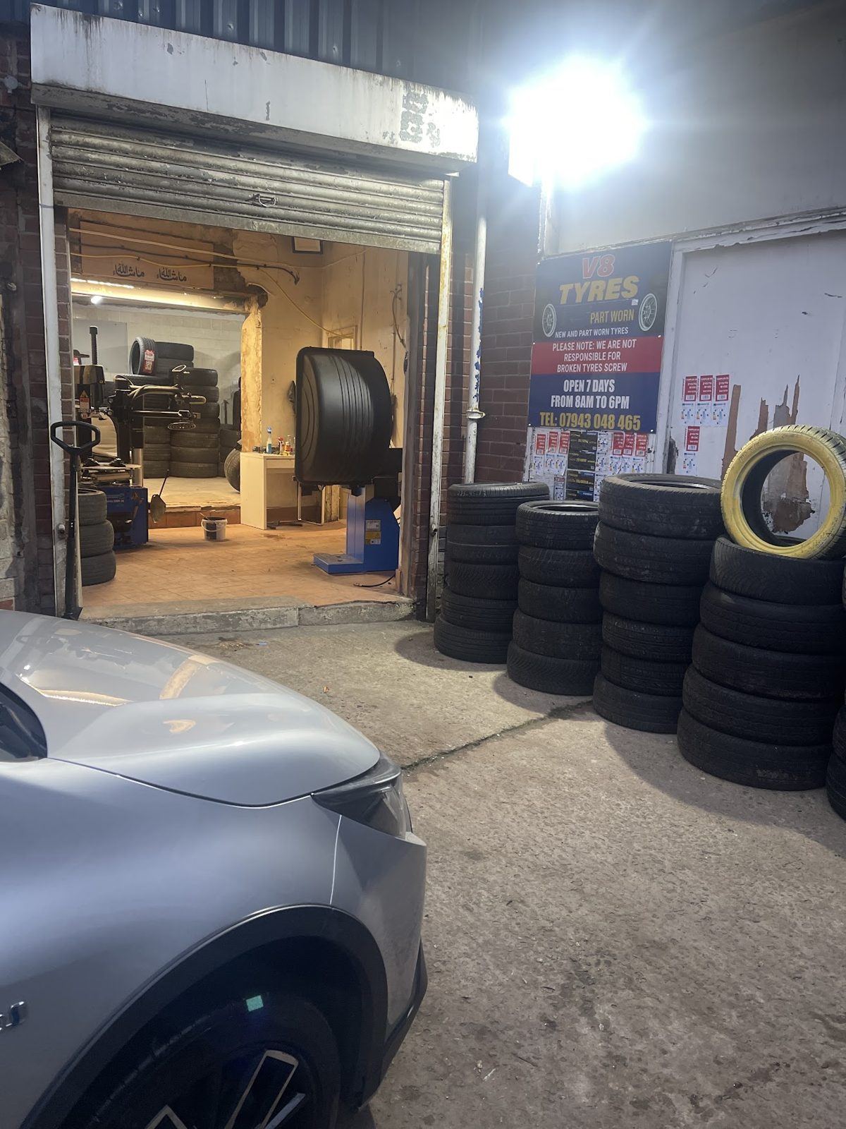 Inside the V8 Tyres unit, shutter up and part worn tyres stacked ready