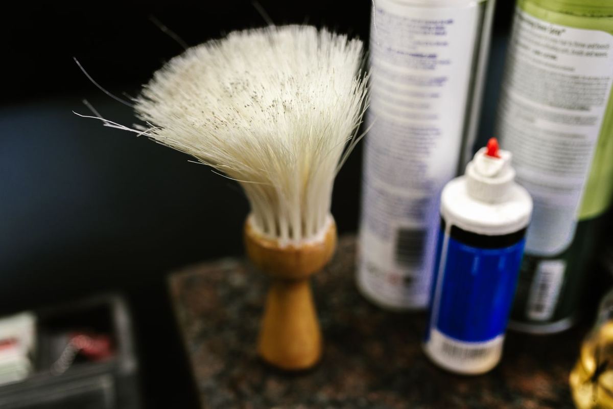 A wooden-handled neck duster in a barber shop
